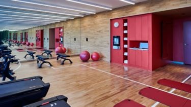 citizenM Menlo Park fitness studio with red accent walls